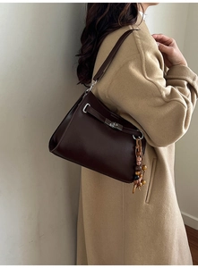Detail of dark brown tote with silver twist-lock and decorative multicolor wood beads