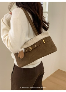 Detail of retro coffee brown faux suede shoulder bag with white fleece trim and heart charm