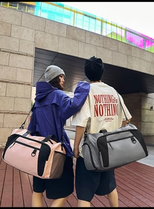 Large travel duffel bag for gym and leisure shown with models in pink and grey