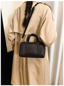 Deep brown Boston bag in lychee texture leather paired with a classic khaki trench coat