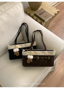 Detail of plush faux fur suede tote bags in black and brown with creative glove charms