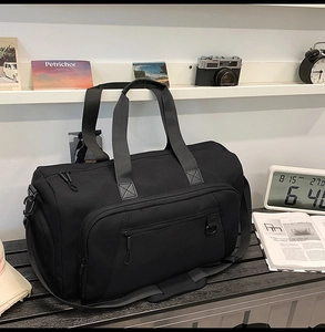 Black waterproof travel bag shown in a stylish home studio with vintage decor