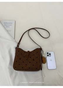 Detailed top view of retro polka dot bucket bag with woven texture and leather strap