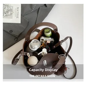 Deep coffee litchi grain leather bucket bag showing spacious interior with essentials