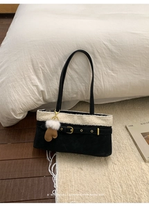 Detail of winter shoulder bag featuring plush white trim and a cute glove-shaped charm