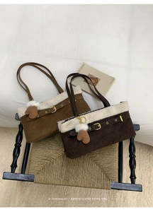 Detail of plush faux fur trim and vintage belt buckle on retro suede shoulder bags