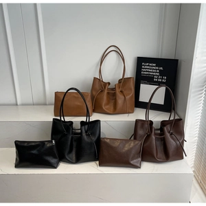 Three-piece tote bag set with matching zip pouches in brown, black, and coffee leather