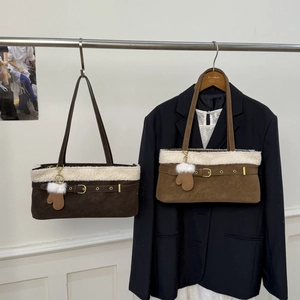 Detail of plush lamb wool trim and suede texture on a vintage brown shoulder bag