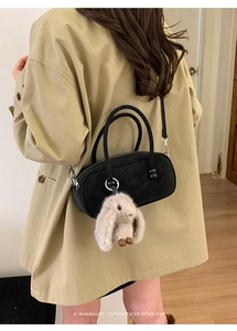 Chic black velvet Boston bag with a cute plush bunny pendant accessory in a retro vibe