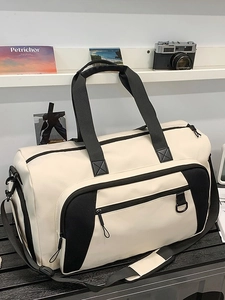 Large capacity travel bag in beige and black with durable handles and shoulder strap