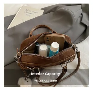 Internal capacity of brown matte bowling bag with phone, lipstick and cream inside
