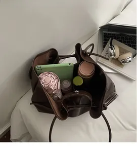 Deep brown tote bag interior showcasing large capacity with tablet and daily essentials
