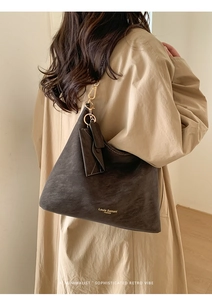 Retro large tote bag in dark coffee leather shown on model for a minimalist chic look