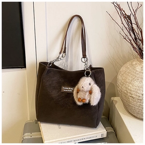 Detailed macro view of dark coffee tote bag with frosted texture and metal chain straps