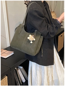 Olive green suede tote bag with teddy bear charm and adjustable shoulder strap