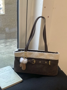 Deep brown matte leather tote bag with white faux fur trim and glove pendant detail