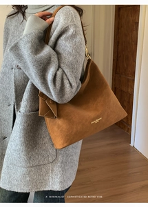 Brown suede tote bag shown on a model in a minimalist autumn winter fashion outfit