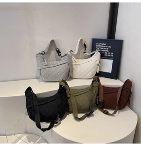 Quilted crescent crossbody bag in five neutral colors with adjustable woven straps