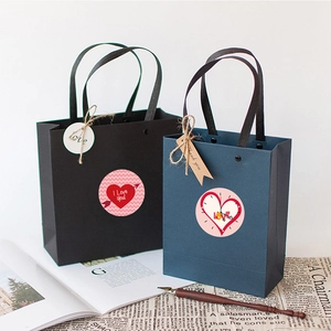 Detail of luxury Valentine gift bags with decorative heart stickers and tags on vintage paper