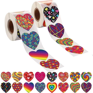 Macro detail of two heart sticker rolls with rainbow and geometric patterns for gift sealing