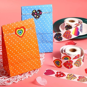 Macro detail of heart-shaped decorative stickers used as gift bag seals for Valentine's Day