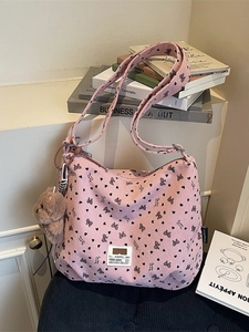 Pink corduroy tote bag with bow patterns and cute plush bear charm for winter fashion