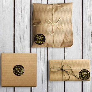 Black and gold Thank You stickers on kraft gift boxes with rustic hemp rope decoration
