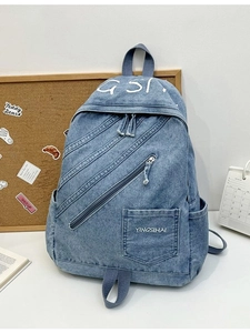 Vintage blue denim backpack with diagonal zipper and large capacity for school and travel