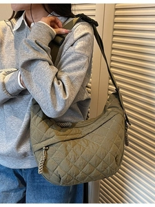 Olive green quilted nylon crescent crossbody bag with adjustable wide shoulder strap