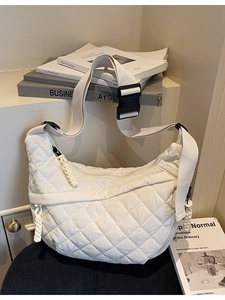 White quilted half-moon crossbody bag with adjustable strap and diamond lattice pattern