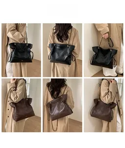 Detail view of quilted tote bag with chain strap and elegant drawstring side accents