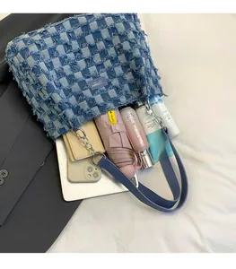 Blue denim tote bag with checkerboard pattern showing large interior space for essentials