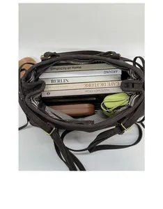 Interior view of spacious dark brown tote bag with striped lining and daily essentials