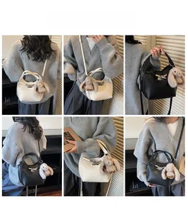 Detailed views of leather bucket bags with silver bow clasp and plush rabbit pendant