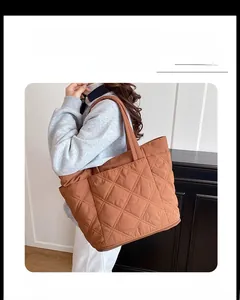 Close-up of caramel quilted tote bag featuring lightweight nylon fabric and large capacity