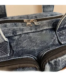 Detail view of denim tote with double metal zippers and high-quality twill texture