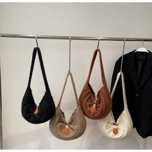 Close-up of knitted tote bags with wooden toggle buttons in multiple colors for winter