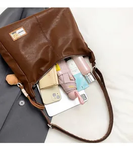 Interior view of large brown tote bag showing capacity for tablet and daily items
