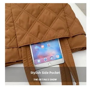 Close-up of the large side pocket on a brown quilted tote bag holding a tablet