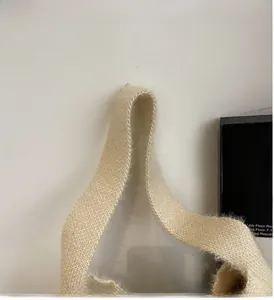 Close-up of the soft knit handbag handle showing dense fuzzy material and reinforced edges