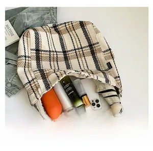 Detailed interior of a large checkered canvas tote bag showing high storage capacity