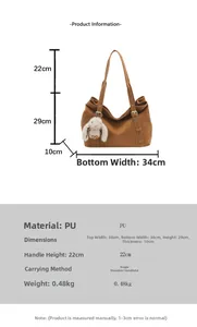 Detail view of large dark brown PU tote bag with decorative strap and plush rabbit charm