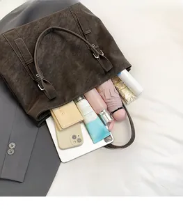 Deep brown matte tote bag showing spacious interior with tablet and daily essentials