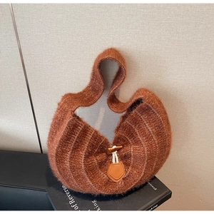 Détail d'un sac à main en peluche marron avec boucle en corne et texture douce