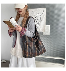 Detailed close-up of retro plaid pattern fabric on a large capacity tote shoulder bag