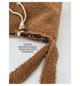 Detailed view of plush brown bag with leopard print lining, drawstring, and horn buckle