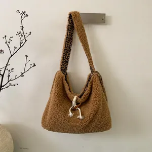 Detail of plush teddy fleece tote with leopard print lining and toggle button closure