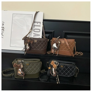 Detail of quilted bucket bags in four colors with heart and leopard print charms