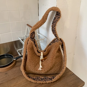Detail of plush tote bag with leopard print lining and drawstring closure on kitchen counter