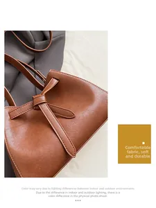 Detail of a brown leather bucket bag showing the unique knot design and soft texture